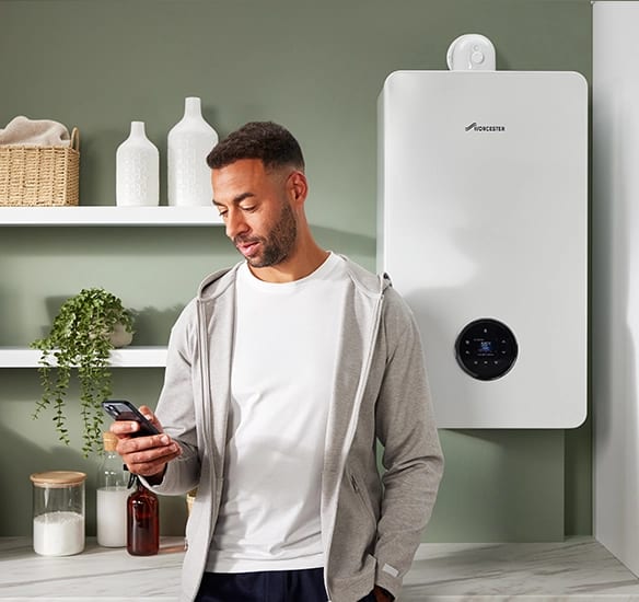Homeowner checking their smart boiler controls from a phone app